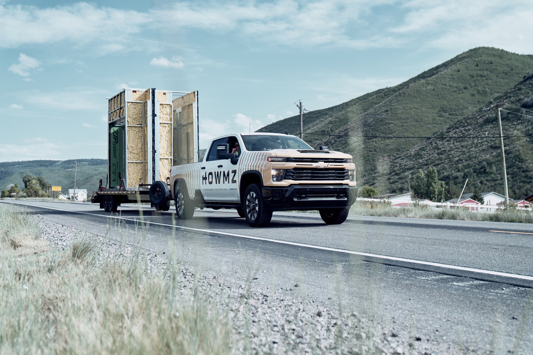 HOWMZ truck delivering wall panels to a job site